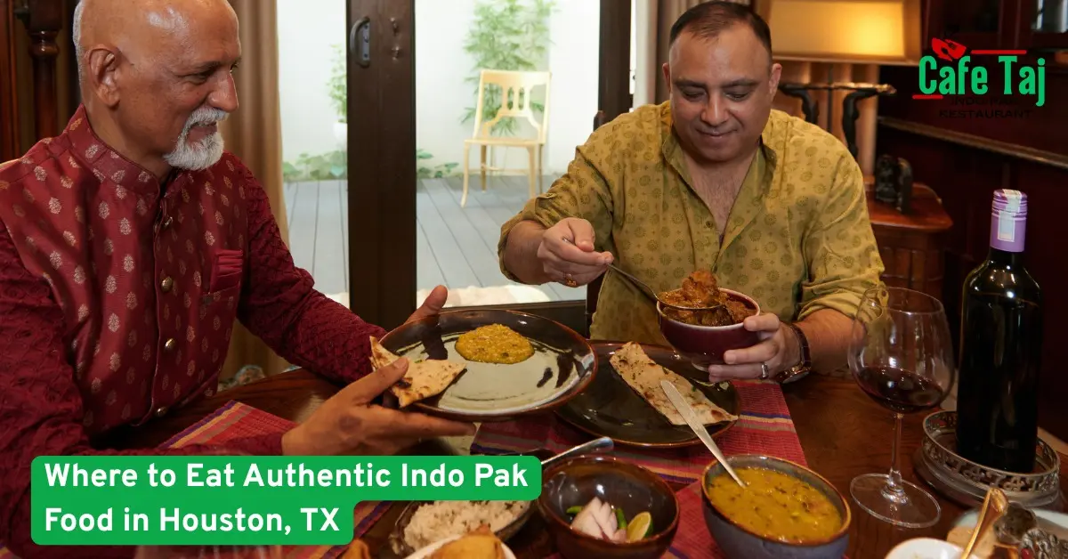 Two men enjoying authentic Indo Pak food with curries and naan at a restaurant in Houston, showcasing traditional Indian and Pakistani dining